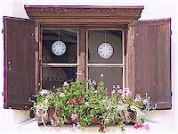 Window with wooden shutters, decorated with flowers