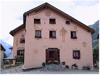 A colourful house decorated with paintings and flowers