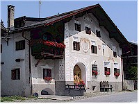 House with a sundial and decorations