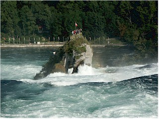 People gathered on the rock in the center of the Rheinfall