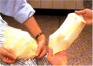 Put the dough over your knee and pull in all directions