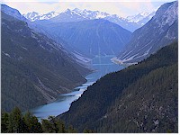 Alp la Schera - Lake Livigno in the foreground, a mountain range in the background
