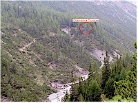 The Chamanna Cluozza hides between the trees high above the valley Cluozza