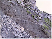 Steep and slippery trail high in the rocks of the Alps